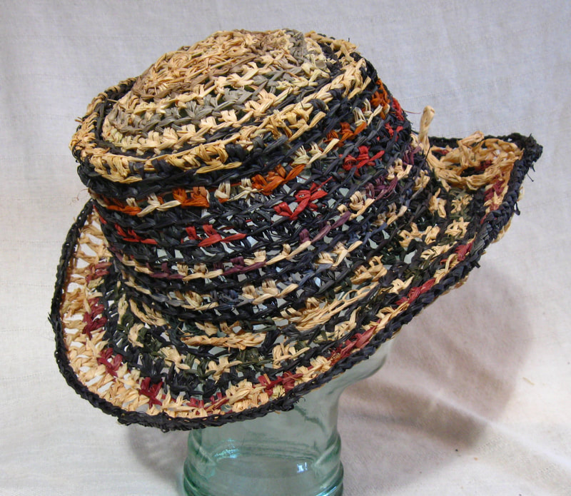 Out of Africa Hat in black, brown, red. Crocheted raffia by C. Buffalo Larkin
