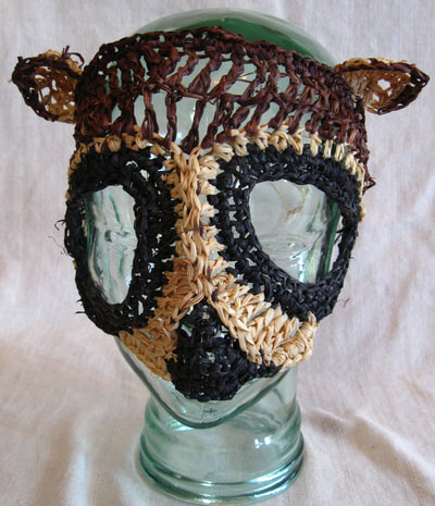 Raccoon Mask, crocheted raffia by C. Buffalo Larkin